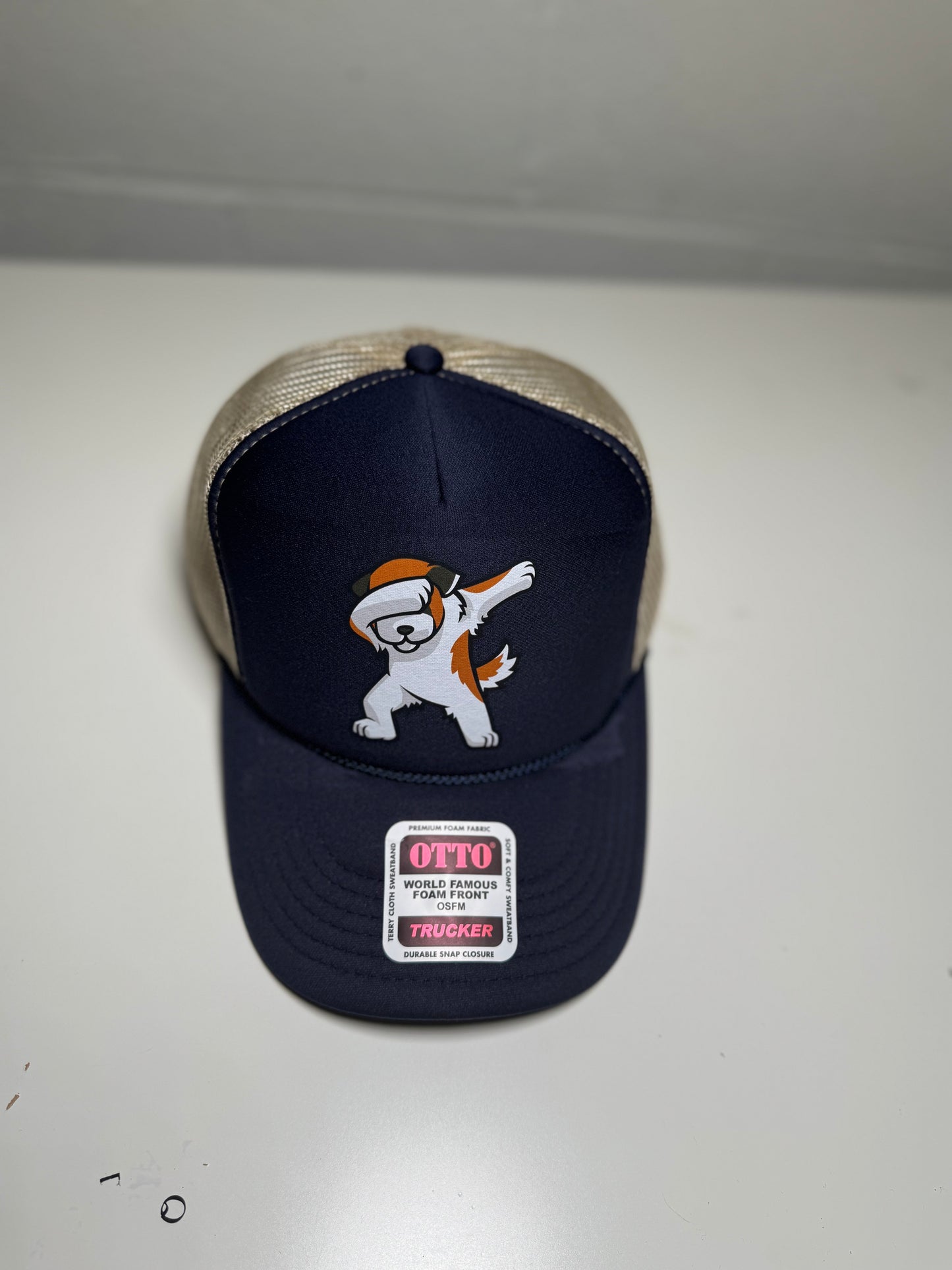 Navy blue cap with a cartoon dog design and 'Otto' branding on a white background