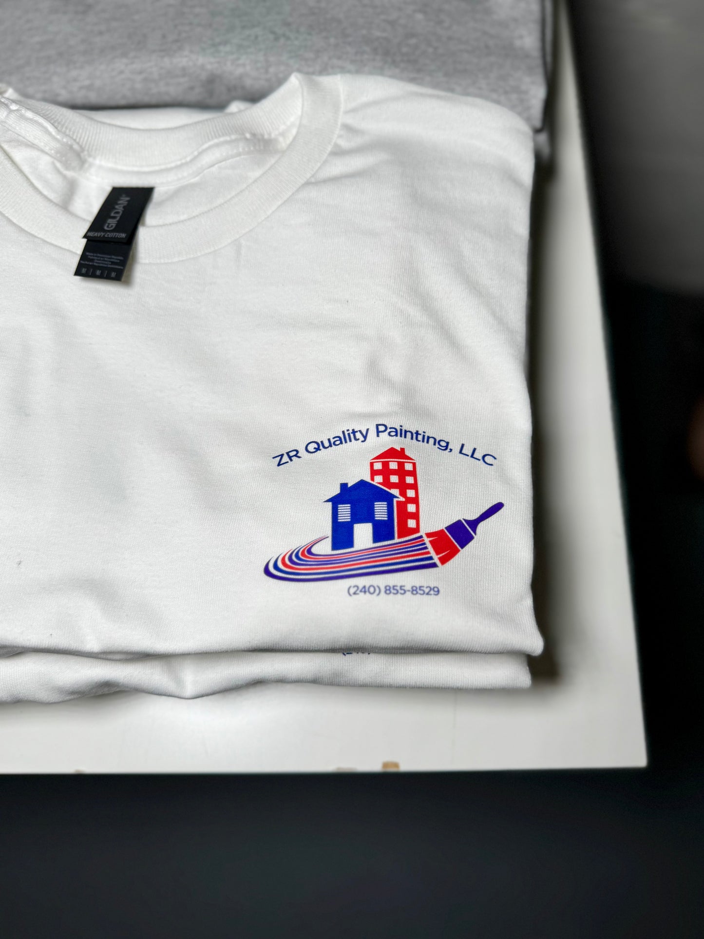 White t-shirt with ZR Quality Painting, LLC logo on a white background