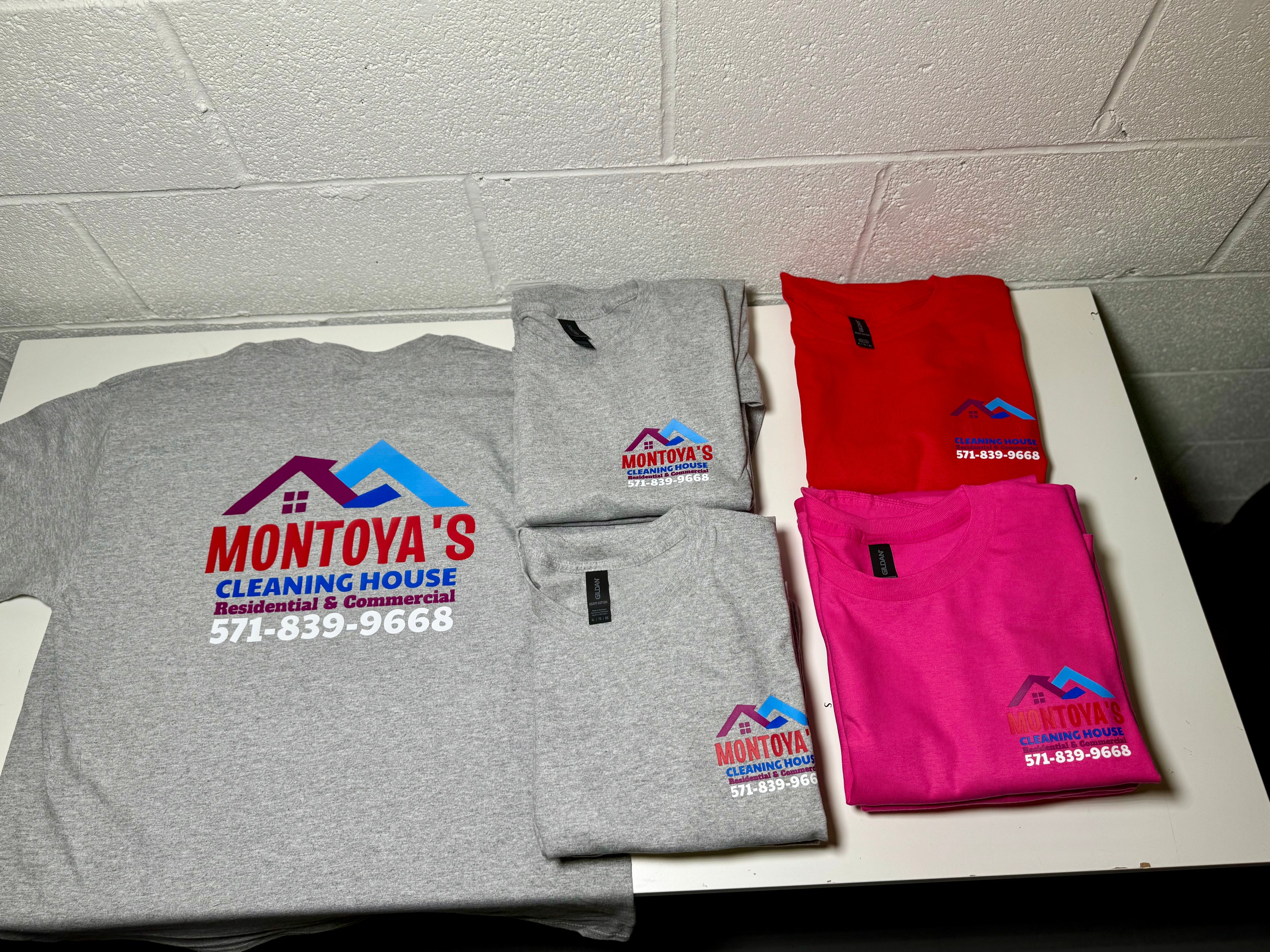 Four folded shirts with Montoya's Cleaning House logo on a tiled floor.