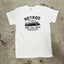 White t-shirt with black graphic design on a concrete surface
