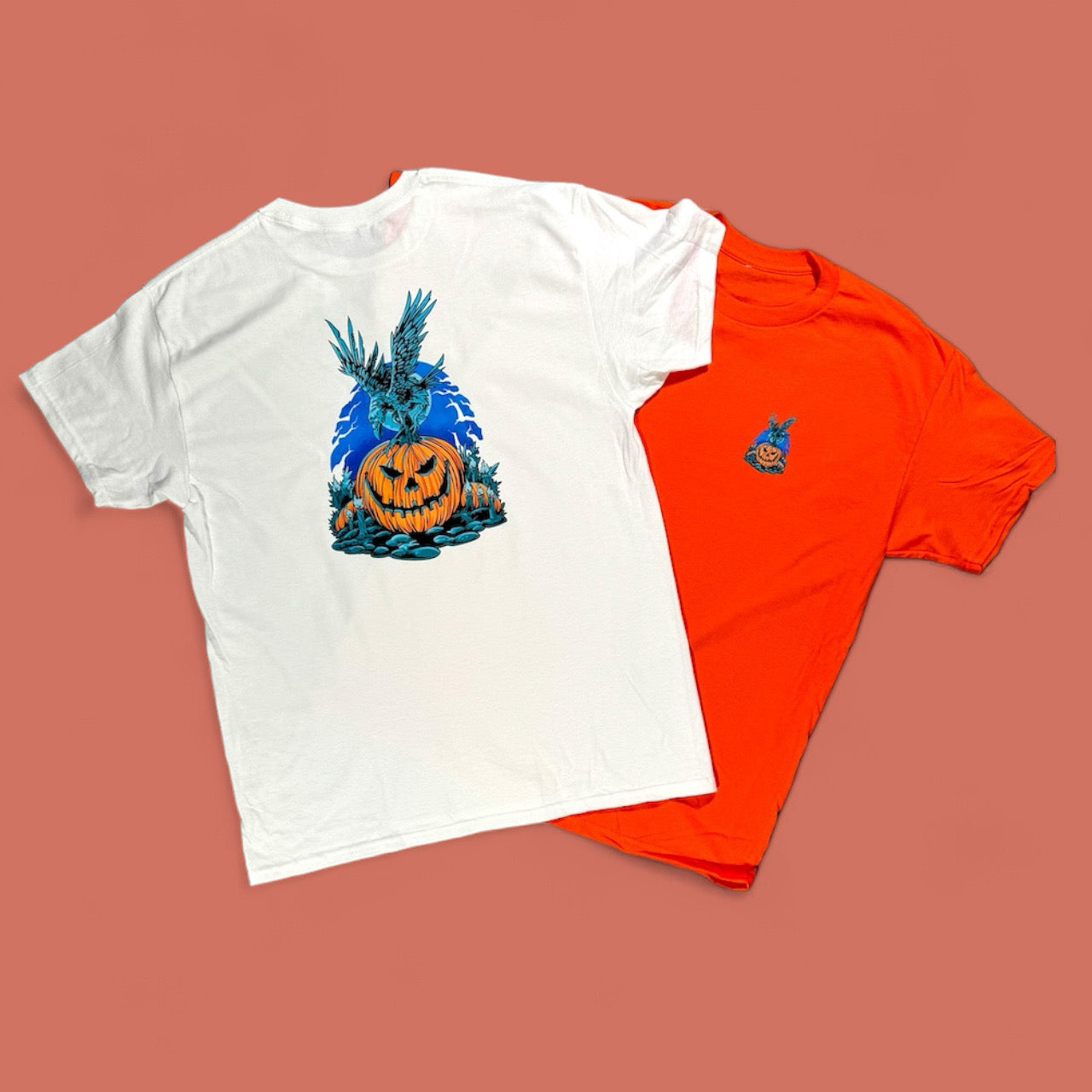 White and orange t-shirts with Halloween-themed designs on a brown background