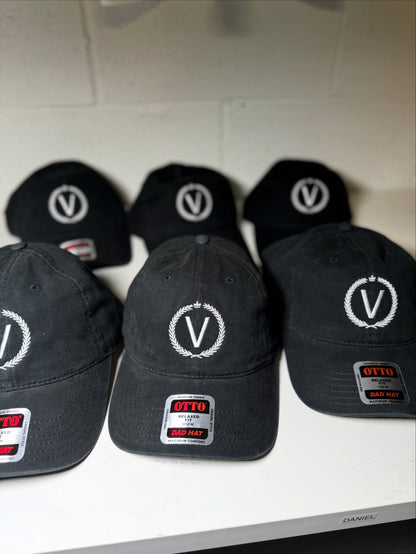 Black caps with a logo and brand name on a white surface