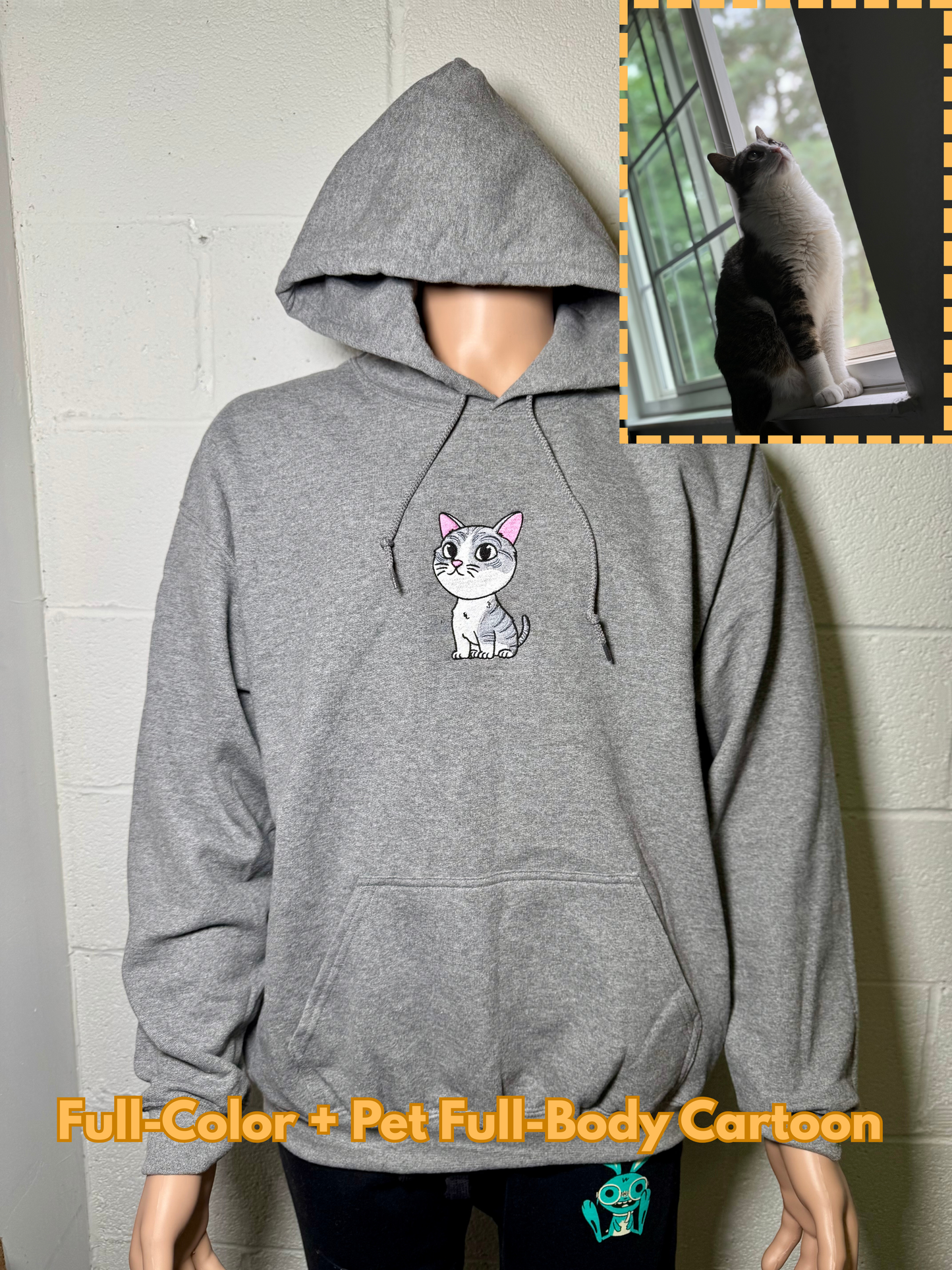 Gray hoodie with a cartoon cat design on the chest, worn by a person, with an inset of a cat looking out a window.