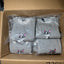 Gray sweatshirts with dog prints in a cardboard box