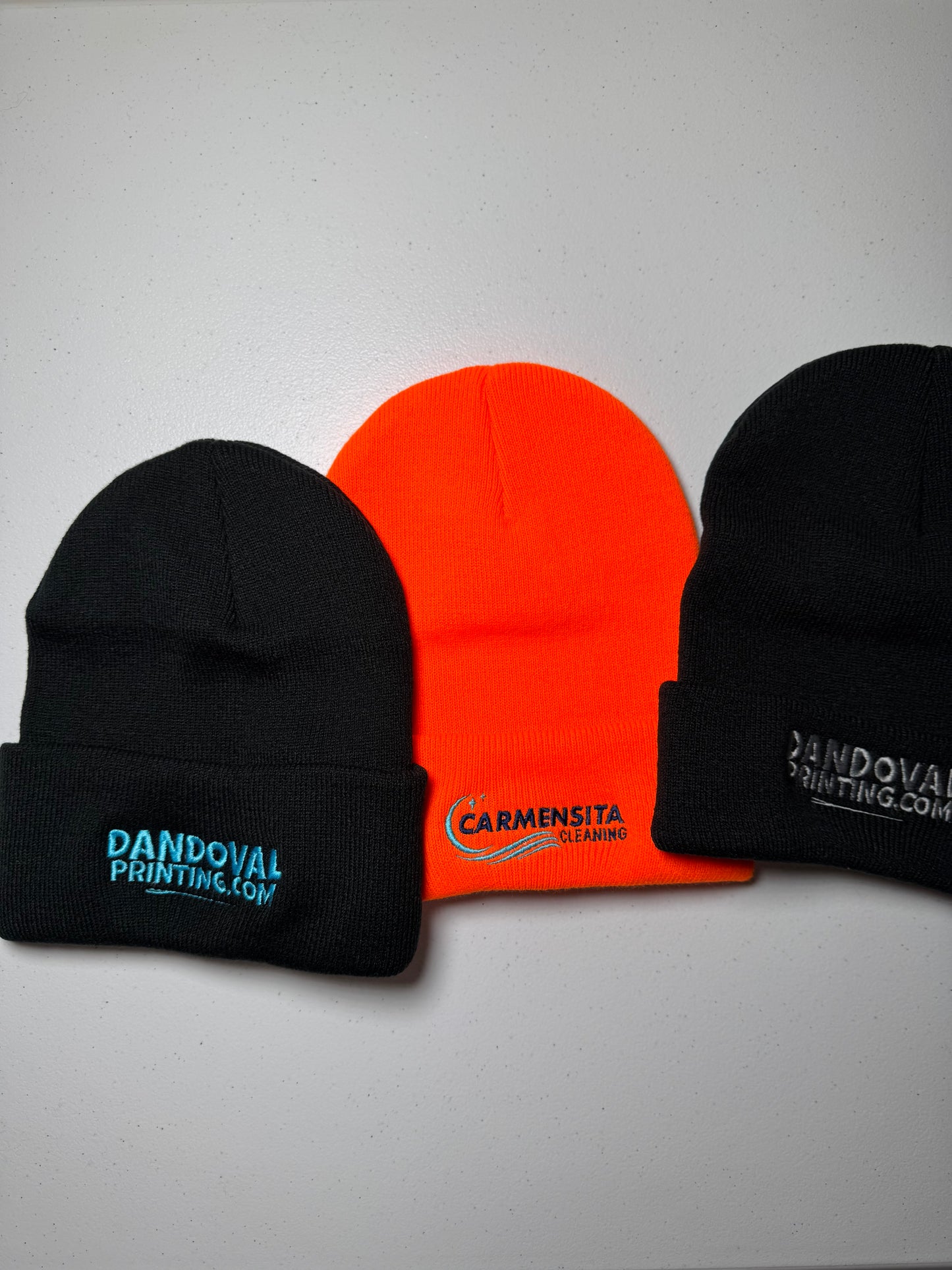 Black and orange socks with branding on a light gray background