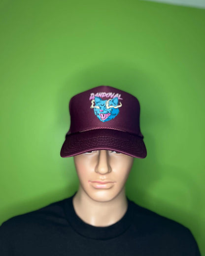 Mannequin head wearing a maroon cap with a logo against a green background