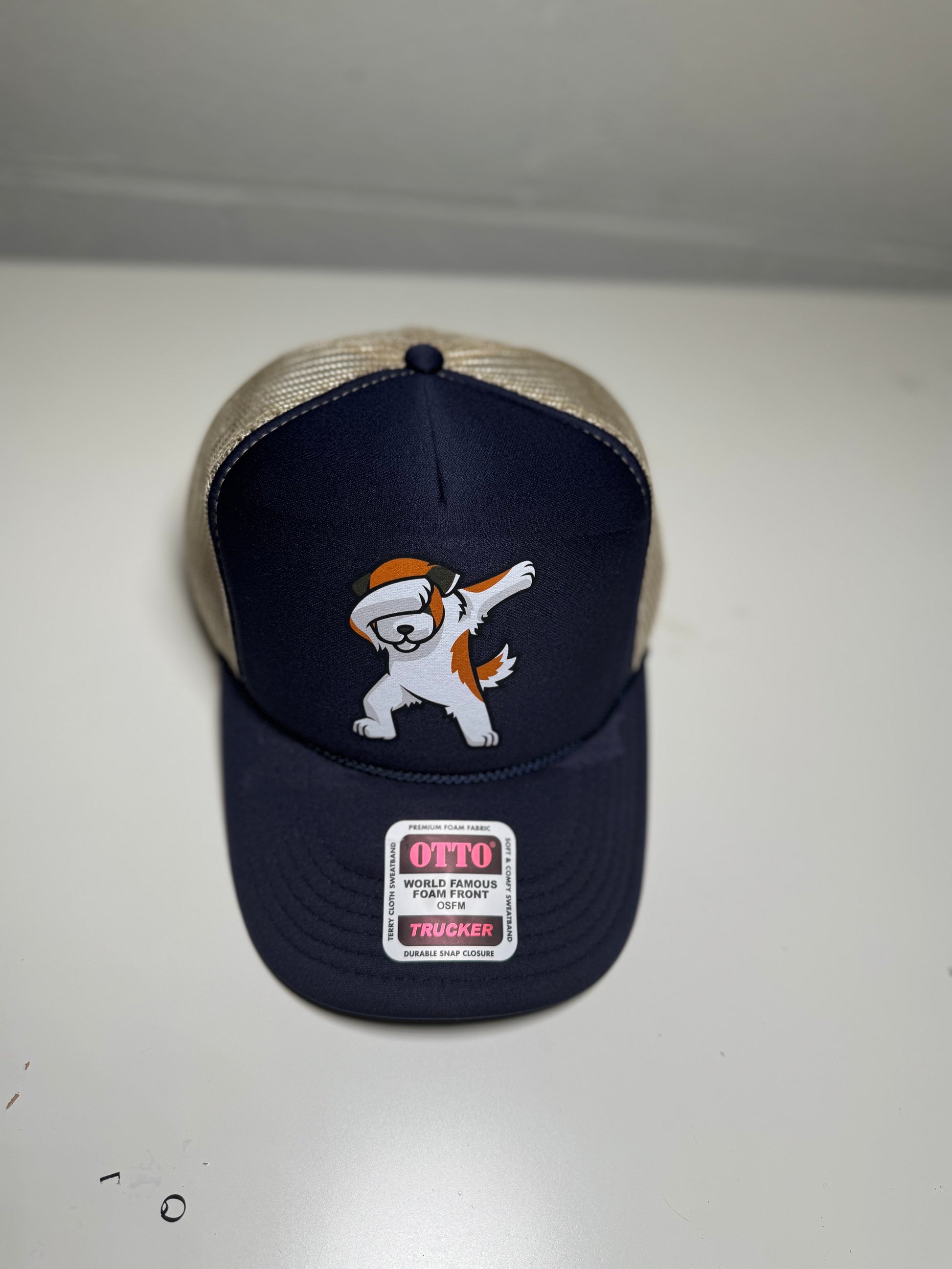 Navy blue cap with a cartoon dog design and 'Otto' branding on a white background