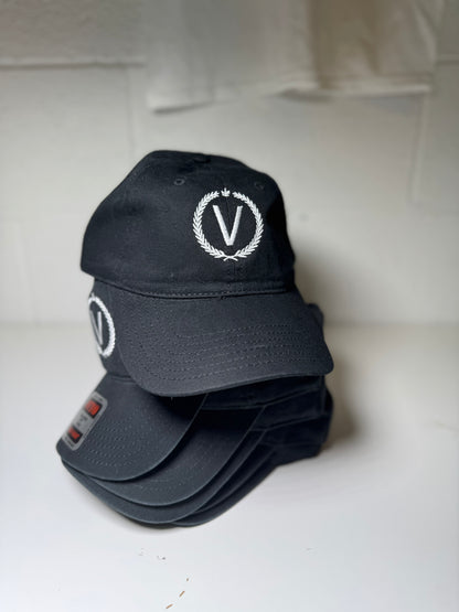 Black cap with a white logo on a light gray background