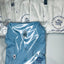 White and blue polo shirts with a logo and contact information on packaging