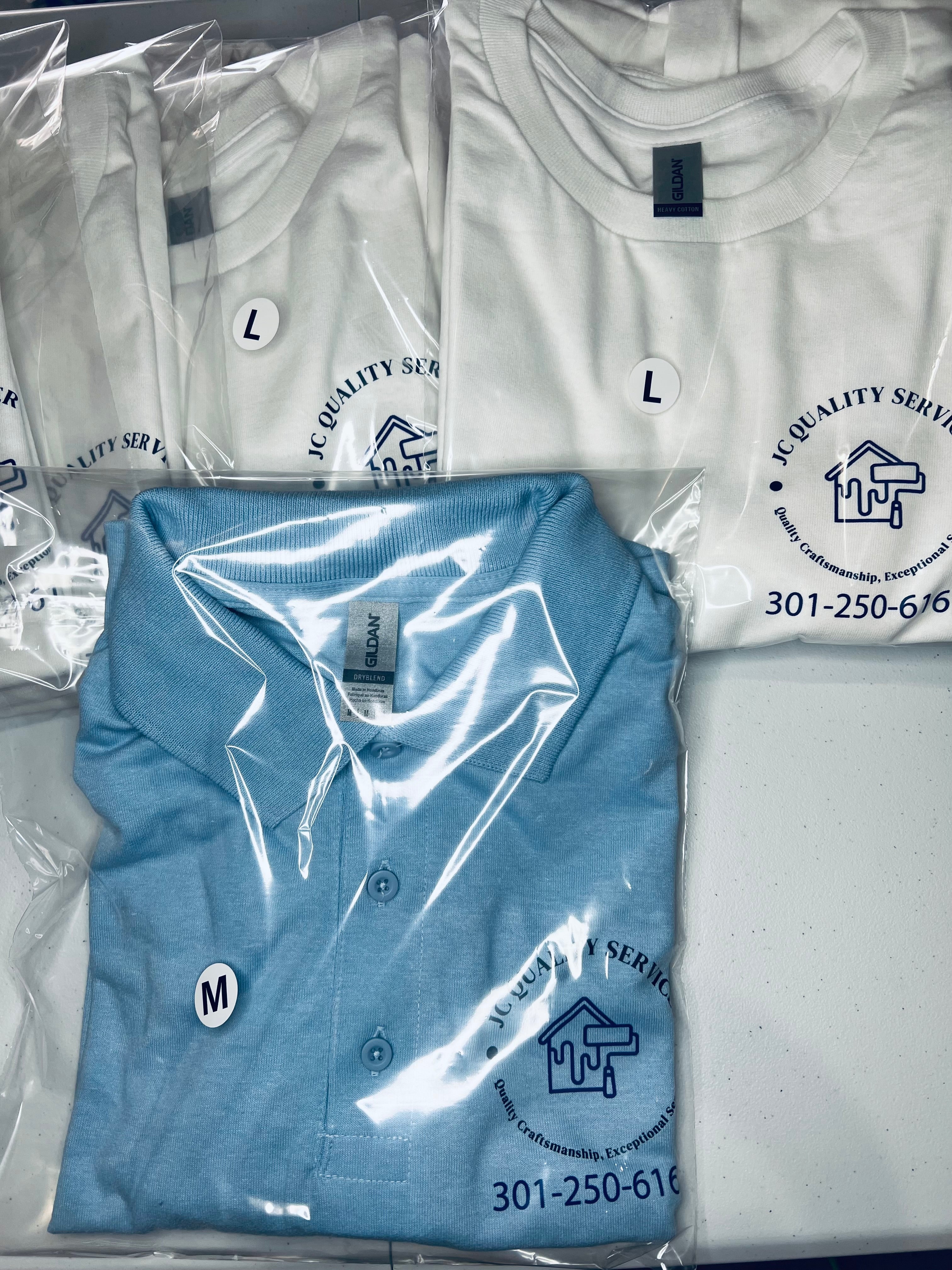 White and blue polo shirts with a logo and contact information on packaging