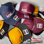 Collection of branded caps with visible logos on a surface