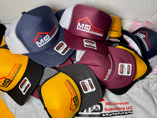 Collection of branded caps with visible logos on a surface