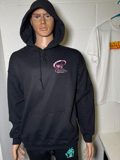 Person wearing a black hoodie with a pink logo on a white floor.