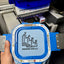 Blue toolbox with 'Yare Remodeling LLC' logo held by a hand, with a machine in the background.