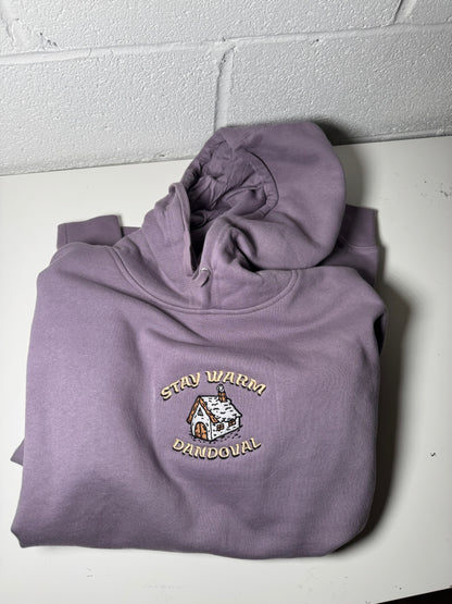 Purple hoodie with a logo on a white surface
