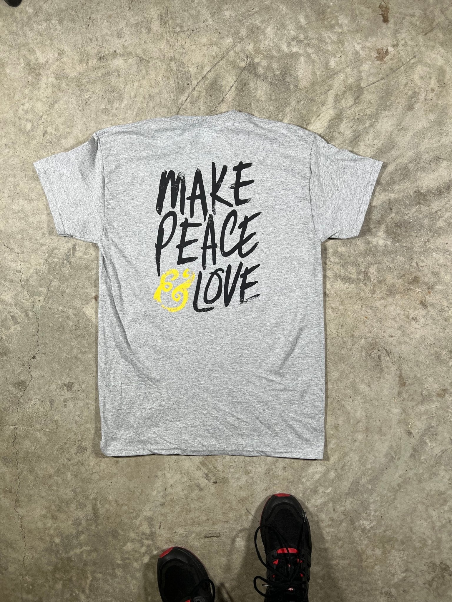 "Back view of MAKE PEACE & LOVE T-Shirt showcasing the distinctive back print, crafted from soft and durable cotton fabric."