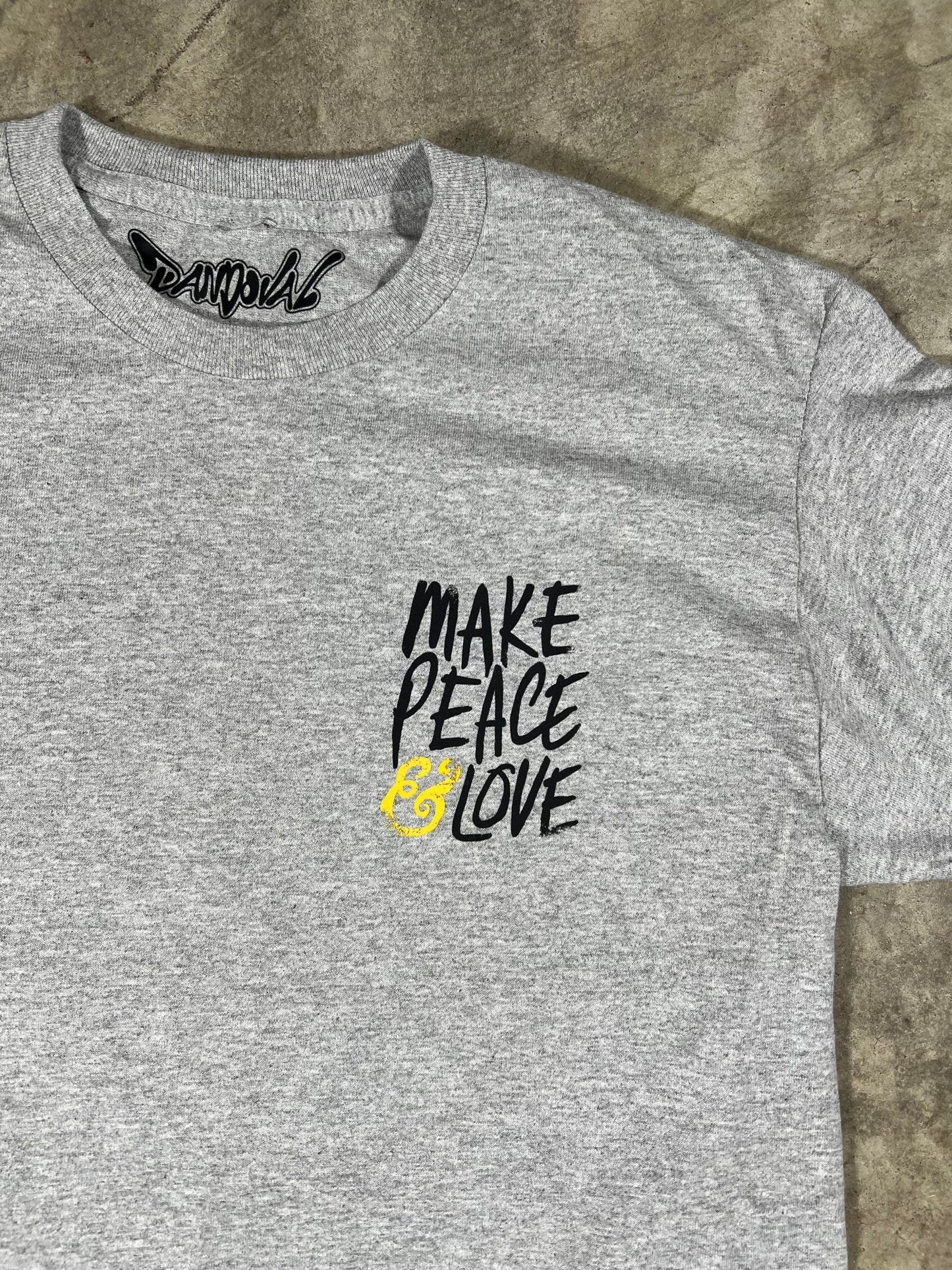 "Close-up of the soft and comfortable 100% combed ringspun cotton fabric of the MAKE PEACE & LOVE T-Shirt."